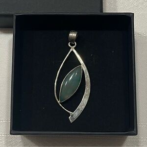 Sterling silver pendant. Green stone. Unique leaf like design. Simple. Classy